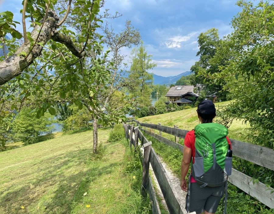 A hiker descends a scenic trail overlooking a quiet Alpine valley - supplied by Eurohike