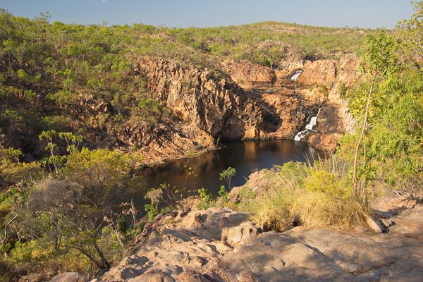 Edith Falls cascading down rocky red gorges into deep, shaded plunge pools within Nitmiluk National Park