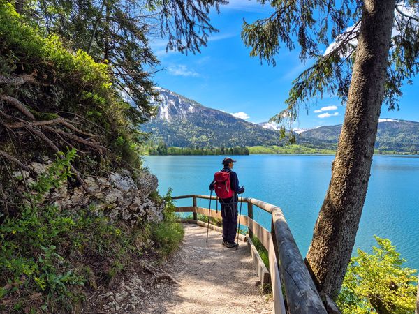 Hiker at an elevated view overlooking Lake Wolfgangsee Austria - supplied by Eurohike