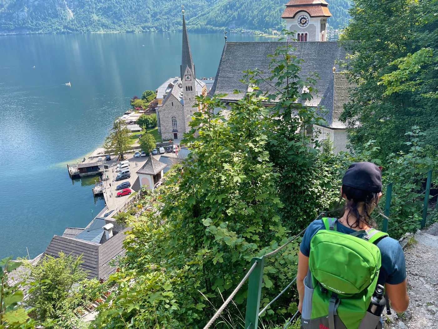 Hiker descends a steep, rocky trail overlooking the village - supplied by Eurohike