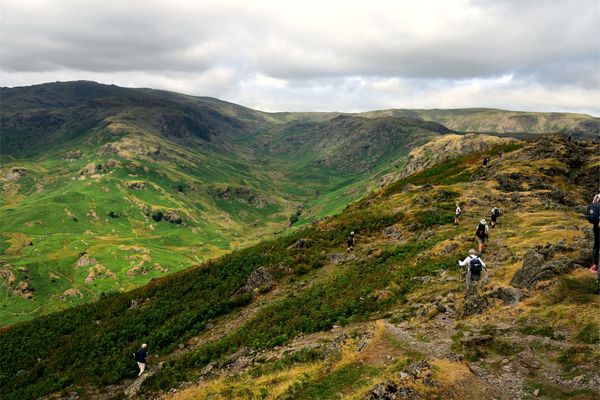 Hikers ascending a rocky trail on Helm Crag