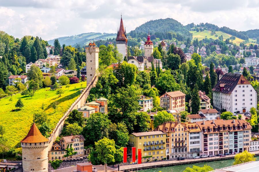 Historic towers and fortified ramparts of the Musegg Wall rising above the city of Lucerne, Switzerland