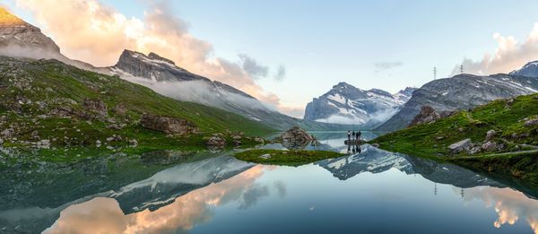 Wildstrubel Panoramic-photo-of-hikers-standing-near-Lake-Daubensee-at-the-Gemmi-Pass-near-Leukerbad-Switzerland-supplied-by-Eurotrek