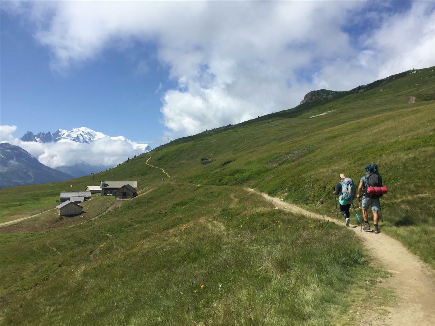 walkers passing remote hut on the TMB