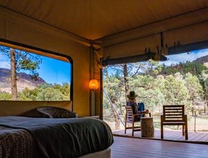 ikara safari camp tent interior with outdoor chairs